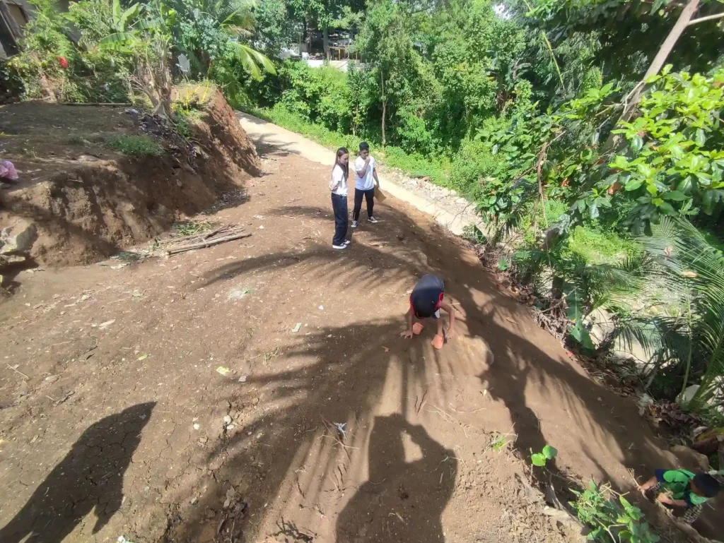 Retaining wall construction sloping terrain requiring reinforcement