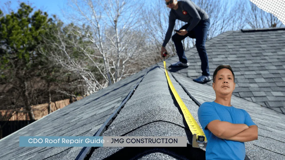 Cdo roof repair guide - jmg construction: a banner image for the cdo roof repair guide by jmg construction. The background shows a roofer using a tape measure to inspect shingles on a sloped roof. In the foreground, engineer jasper gementiza, wearing a blue shirt, stands confidently with his arms crossed, symbolizing expertise in roof repair and construction. The clean design with a text overlay emphasizes the guide’s professional focus on roofing services in cagayan de oro.