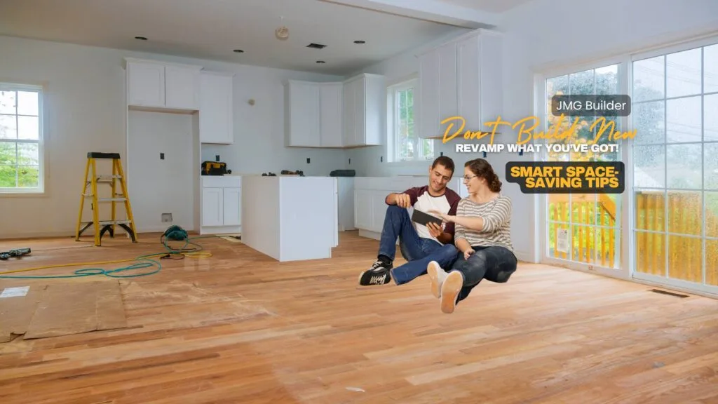 Don’t build new—revamp what you’ve got! Smart space-saving tips Budget-friendly home renovation tips. A young couple sitting on the floor of a partially renovated kitchen, reviewing renovation plans on a tablet. The space features newly installed hardwood floors, white cabinets, and construction tools, with text promoting "jmg builder" and "smart space-saving tips. "