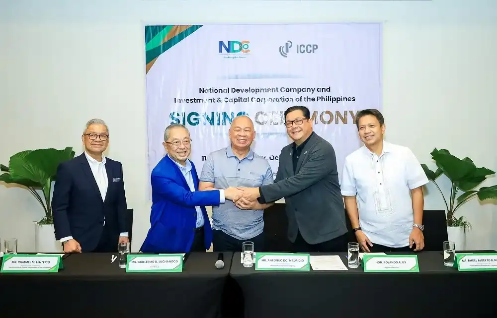 Silicon valley-inspired development National development company (ndc) and iccp group signing ceremony for the silicon valley-inspired development in cagayan de oro. Key officials are seen shaking hands and celebrating the partnership, with the event banner displayed in the background.
