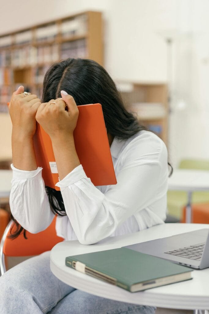 Overcoming challenges with grit and strategy A frustrated individual at a desk, overwhelmed with documents and planning challenges in project bidding.