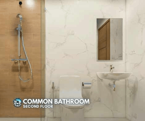 Stylish and functional common bathroom Modern bathroom with marble walls, a sink, shower, and toilet.