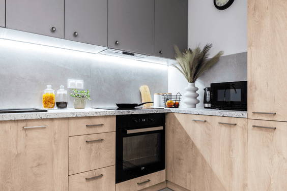 🍽️ modern kitchen Contemporary kitchen with light wood cabinets, white quartz countertops, matte black faucet, and a subway tile backsplash.