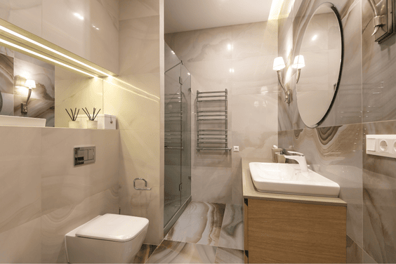 🧼 bathrooms designed like a hotel (1) Sleek, wall-mounted split-type air conditioning unit in a bright living space with soft curtains and a beige couch.