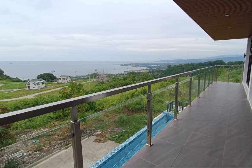 Scenic balcony – jmg design & build in teakwood hills, cdo Modern balcony with glass railing by jmg overlooking macajalar bay from teakwood hills luxury mansion
