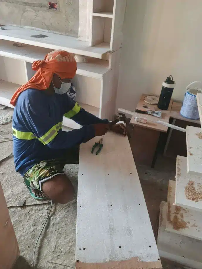 Cabinet surface finishing and smoothing preparation during Villanueva interior fit-out