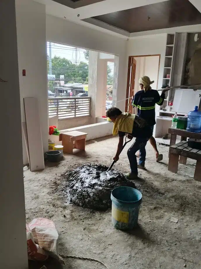 Concrete mixing for tile works during Villanueva residential interior fit-out