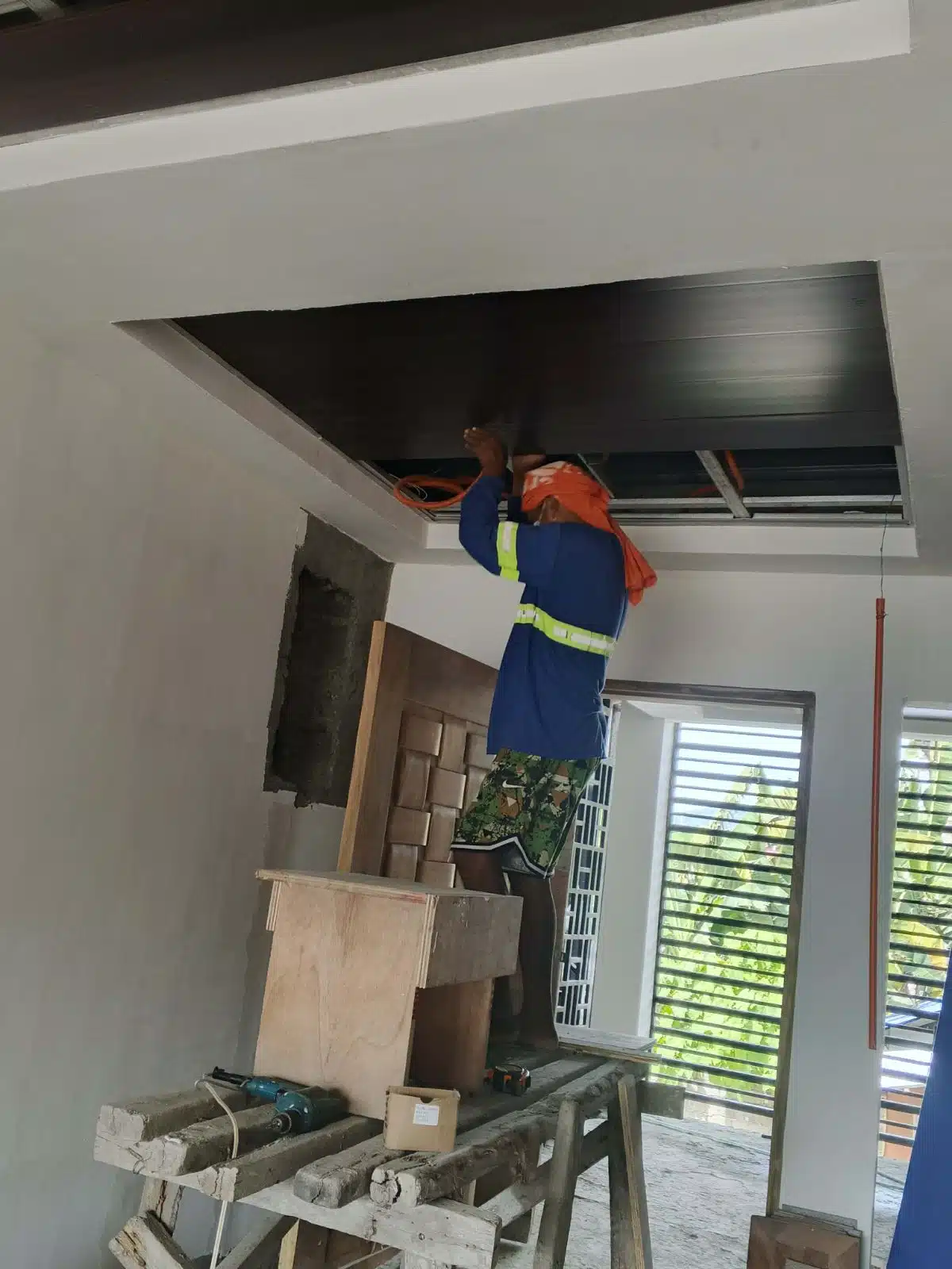 Living room PVC ceiling installation during Villanueva interior fit-out