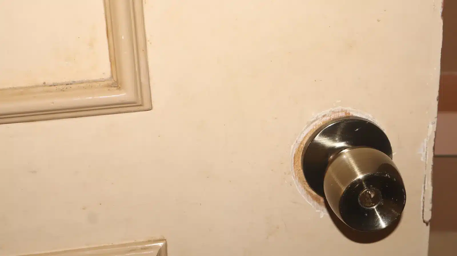 Property condition assessment & indicative value range: camella gran europa, lumbia, cagayan de oro 20 Cream-painted interior panel door with a brass door knob and worn paint around the lockset, camella gran europa house, cagayan de oro