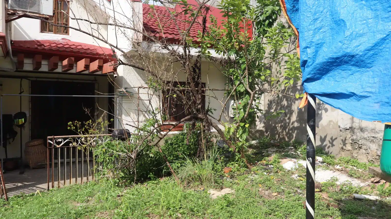 Property condition assessment & indicative value range: camella gran europa, lumbia, cagayan de oro 1 Front elevation of a two-storey camella gran europa house in lumbia, cagayan de oro, with red tile roof, weathered walls and overgrown side yard