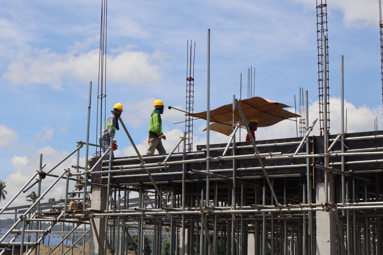 Workers inspect elevated formwork and scaffolding at a jmg tagoloan project